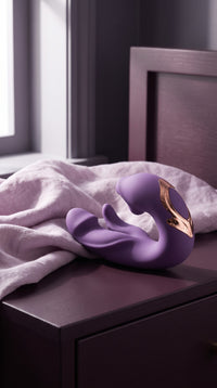 Purple ÉLAN on a bedside table beside lavender linens