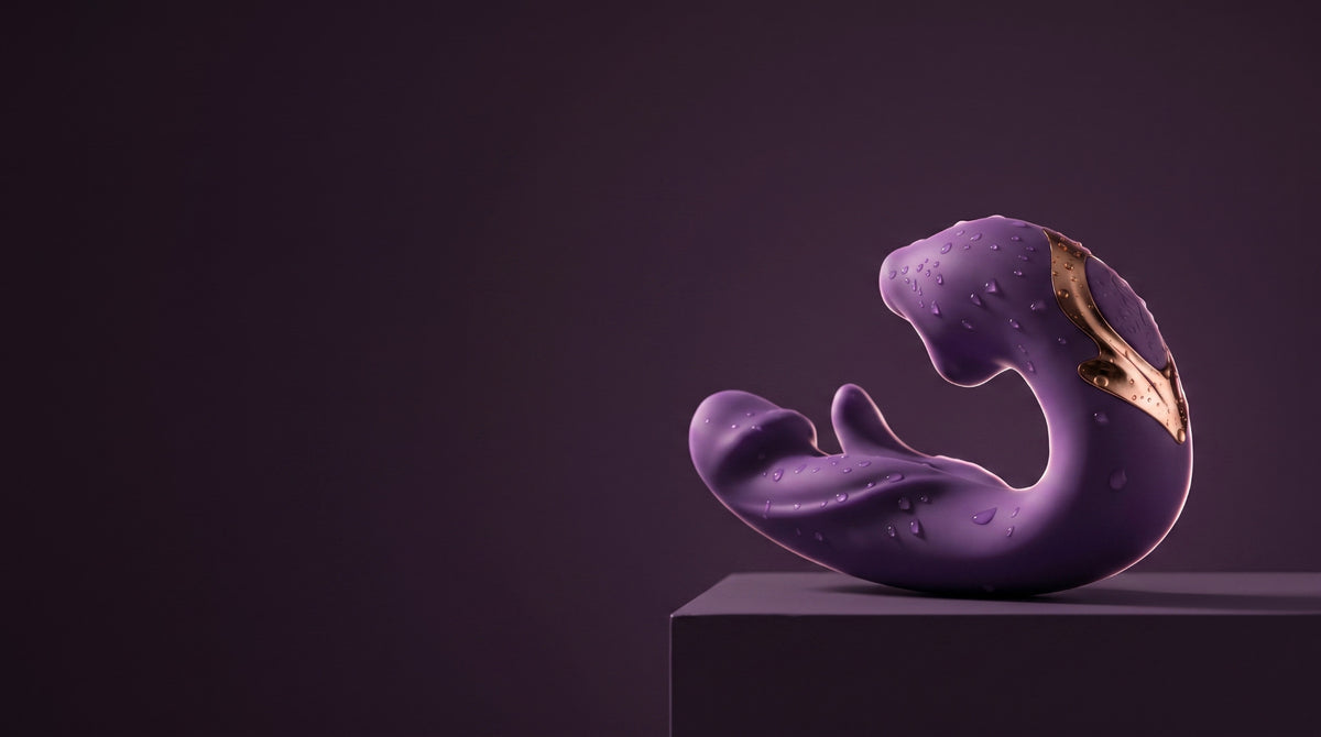 Purple ÉLAN with water droplets on a dark plum pedestal