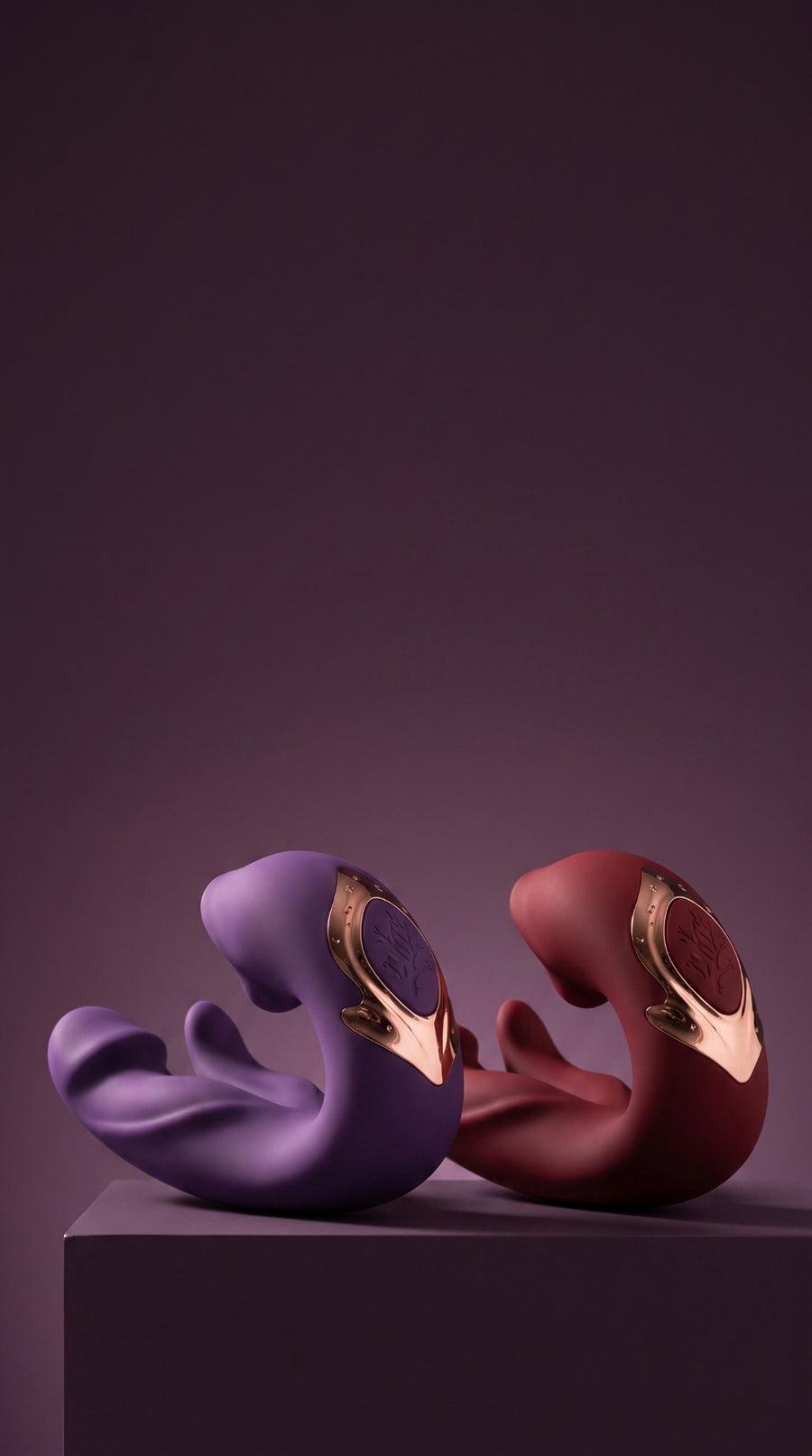 Purple and Red ÉLAN on a dark plum pedestal